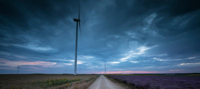 wind turbine in a field at dusk