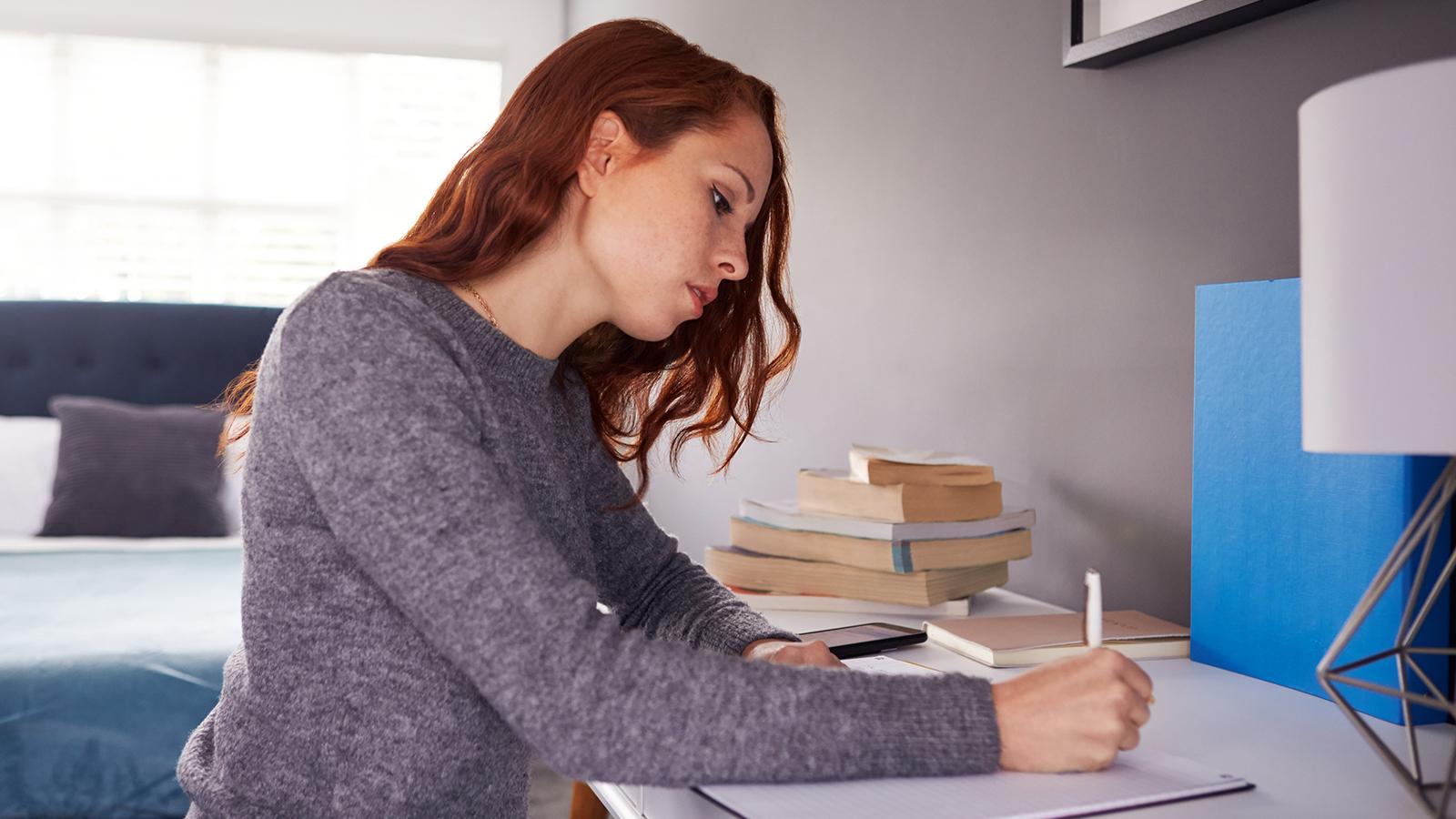 female college student working on a paper