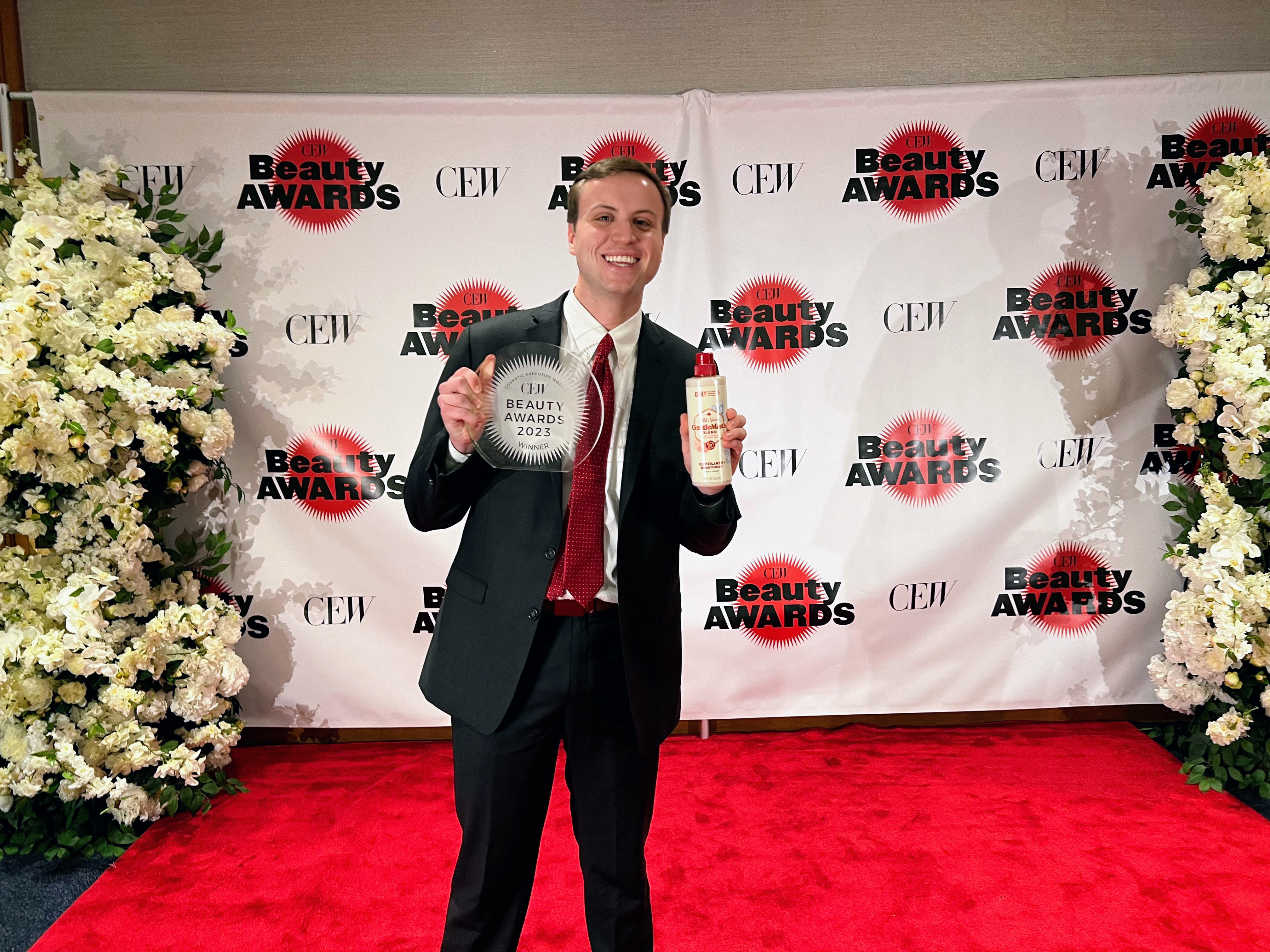 Matthew Bonner holding Old Spice body wash and award