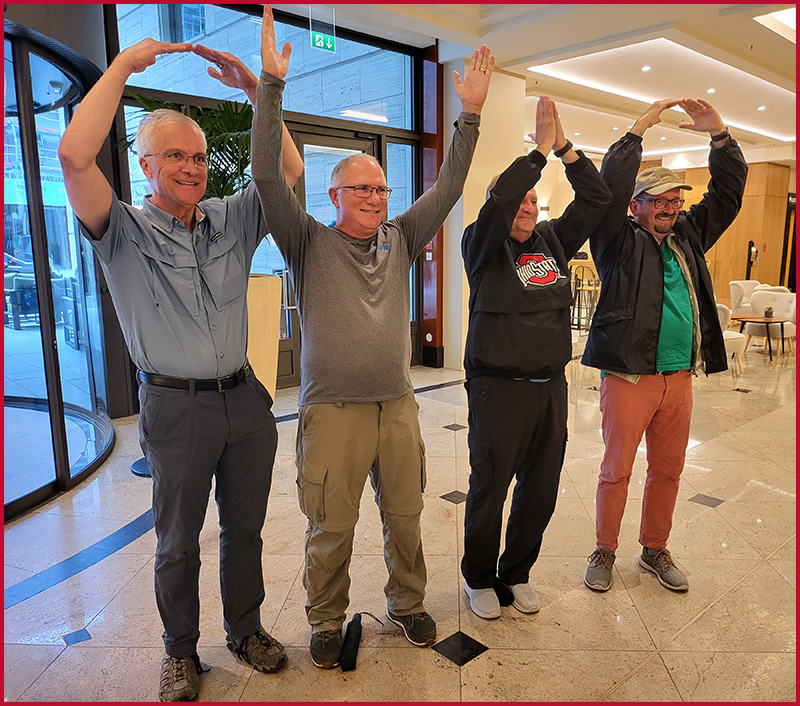 Faculty hosts, Peter Hahn, Peter Mansoor, David Steigerwald, and tour guide Christian Mauer show off their Ohio State pride.