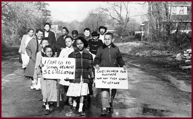 Sixteen Black children accompanied by four mothers carry anti-segregation signs in Hillsboro, Ohio, in 1956. (Bettmann Collection/Getty Images)