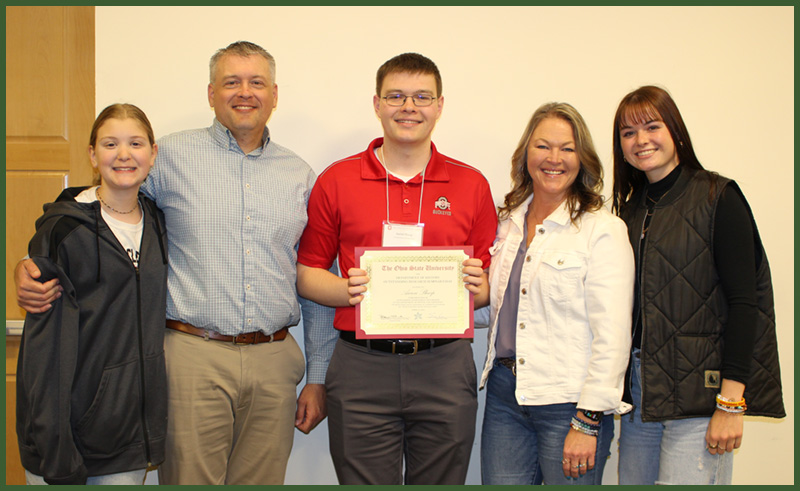 Outstanding Research Seminar Essay winner, Aaron Sharp, surrounded by family.