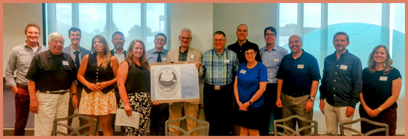 John Brooke surrounded by attendees of the John Brooke Retirement Conference organized  by former students.