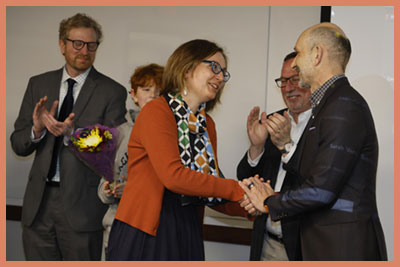 Professor Dragostinova accepting Distinguished Alumni Award while Scott Levi, and her husband and son look on