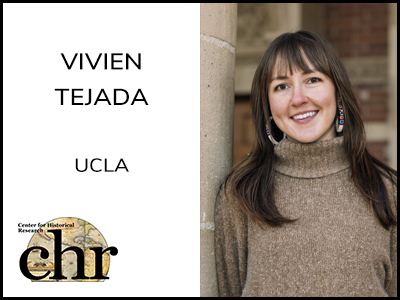 Vivien Tejada standing beside a stone wall smiling