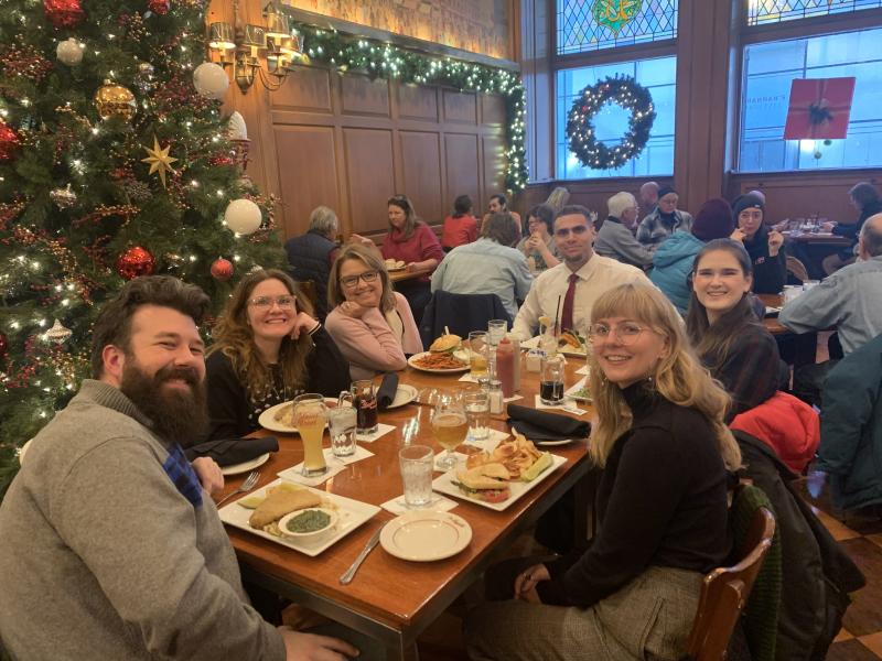 graduate students celebrate at a luncheon with Prof. Birgitte Soland