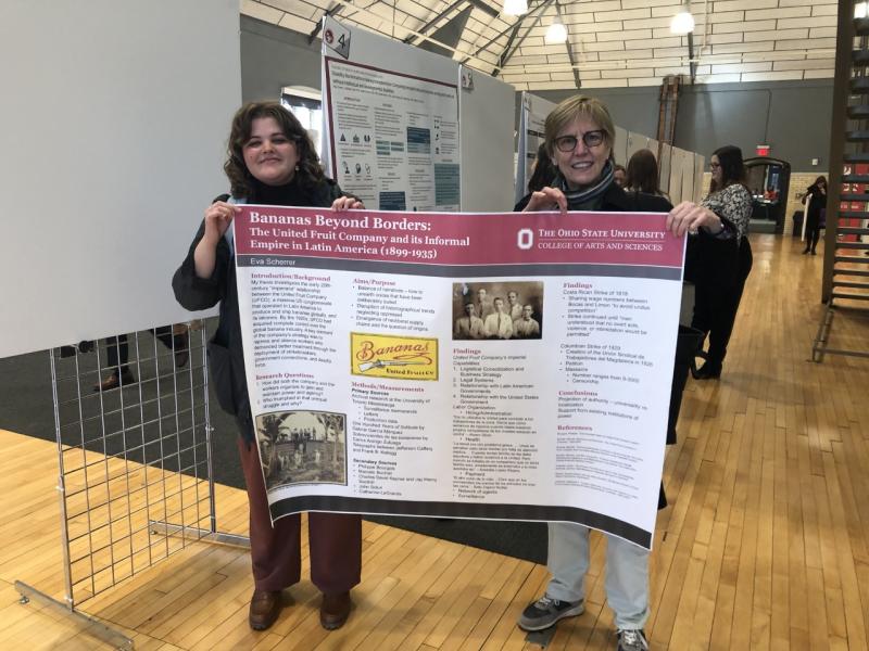 Eva Scherrer and Alice Conklin holding poster about Eva's project