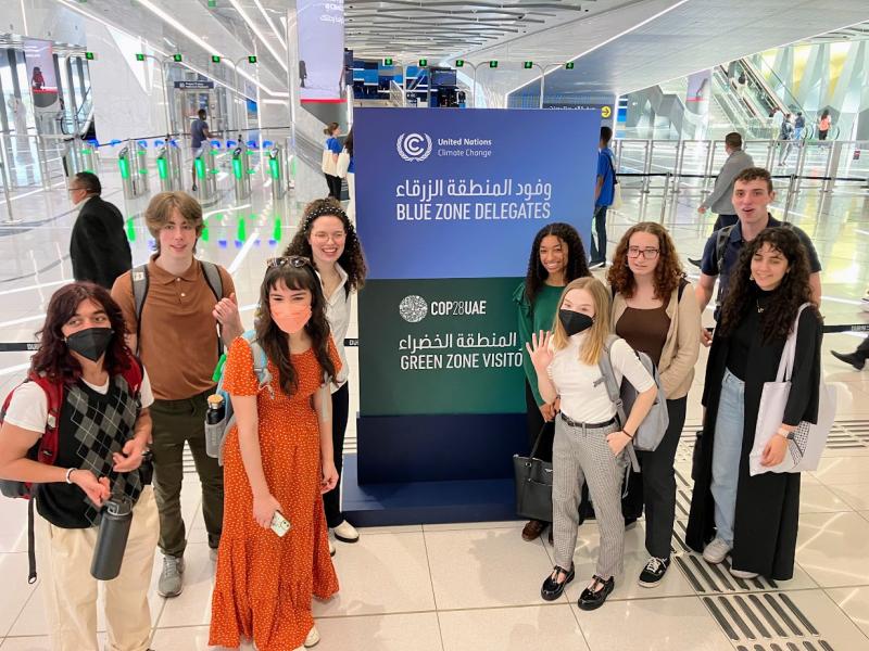 Ohio State students standing in front of sign at Climate Summit