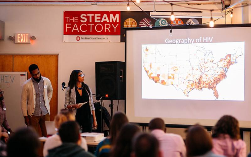 Students conduct presentations on HIV at the STEAM Factory in downtown Columbus. Photo courtesy Paul Woo, Wandering Woo Photography
