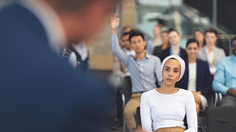 people listening to a speaker