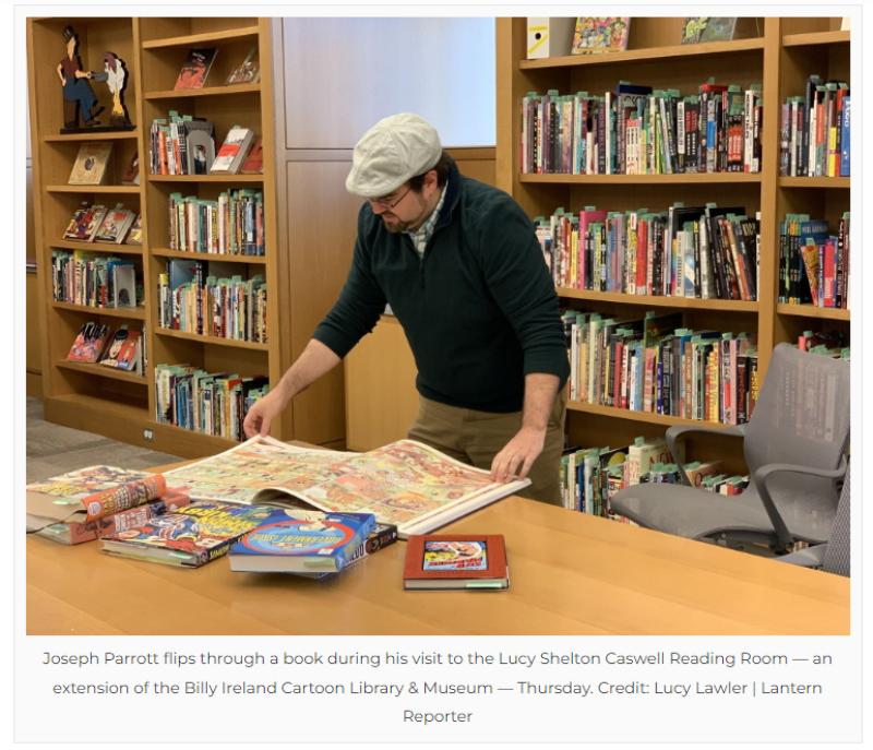 Joe Parrott looking at book of comics in the Lucy Shelton Caswell Reading Room (Photo: Lucy Lawler, Lantern Reporter)