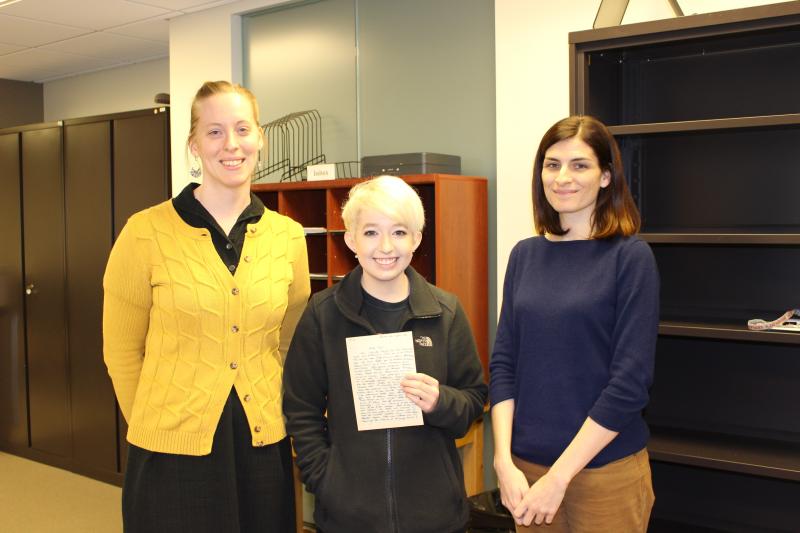 Jenna Cosentino, holding a manuscript letter from a German soldier fighting in World War II to his fiancée. With supervisors Cate Putirskis (L) and Jolie Braun (R).