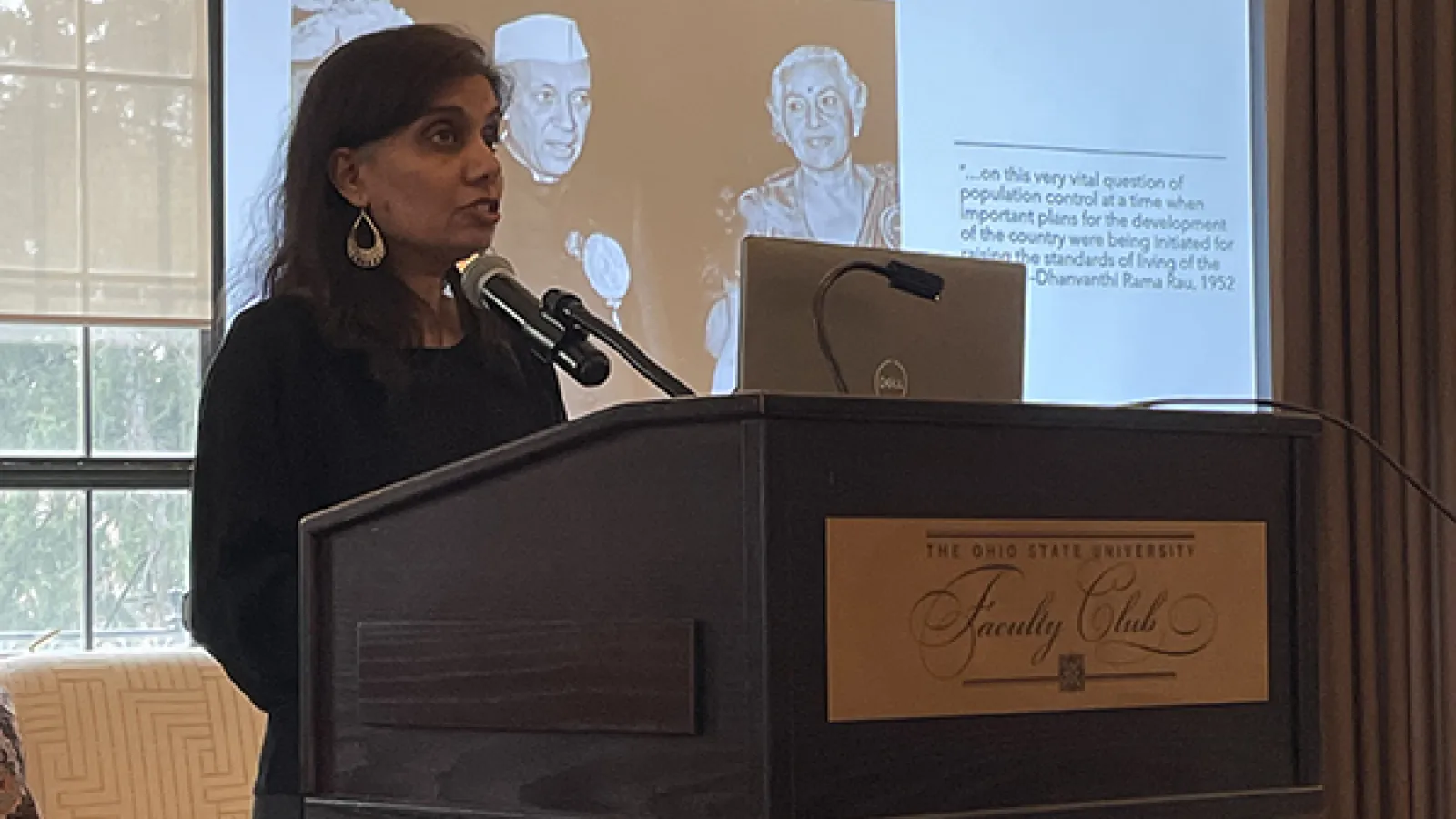 Mytheli Sreenivas standing at a podium
