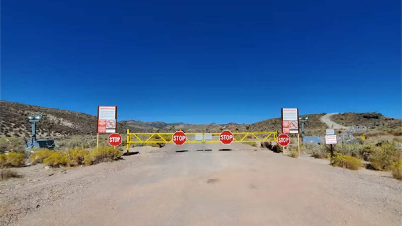 area 51 with a road and signs that say Stop