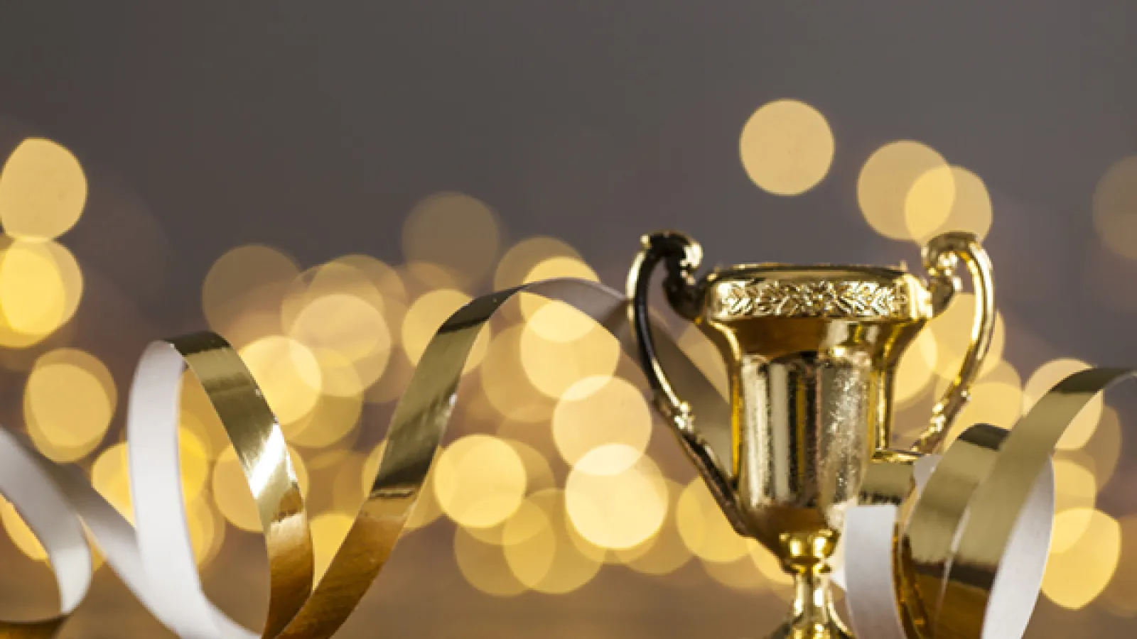 gold glitter ribbons and a gold trophy