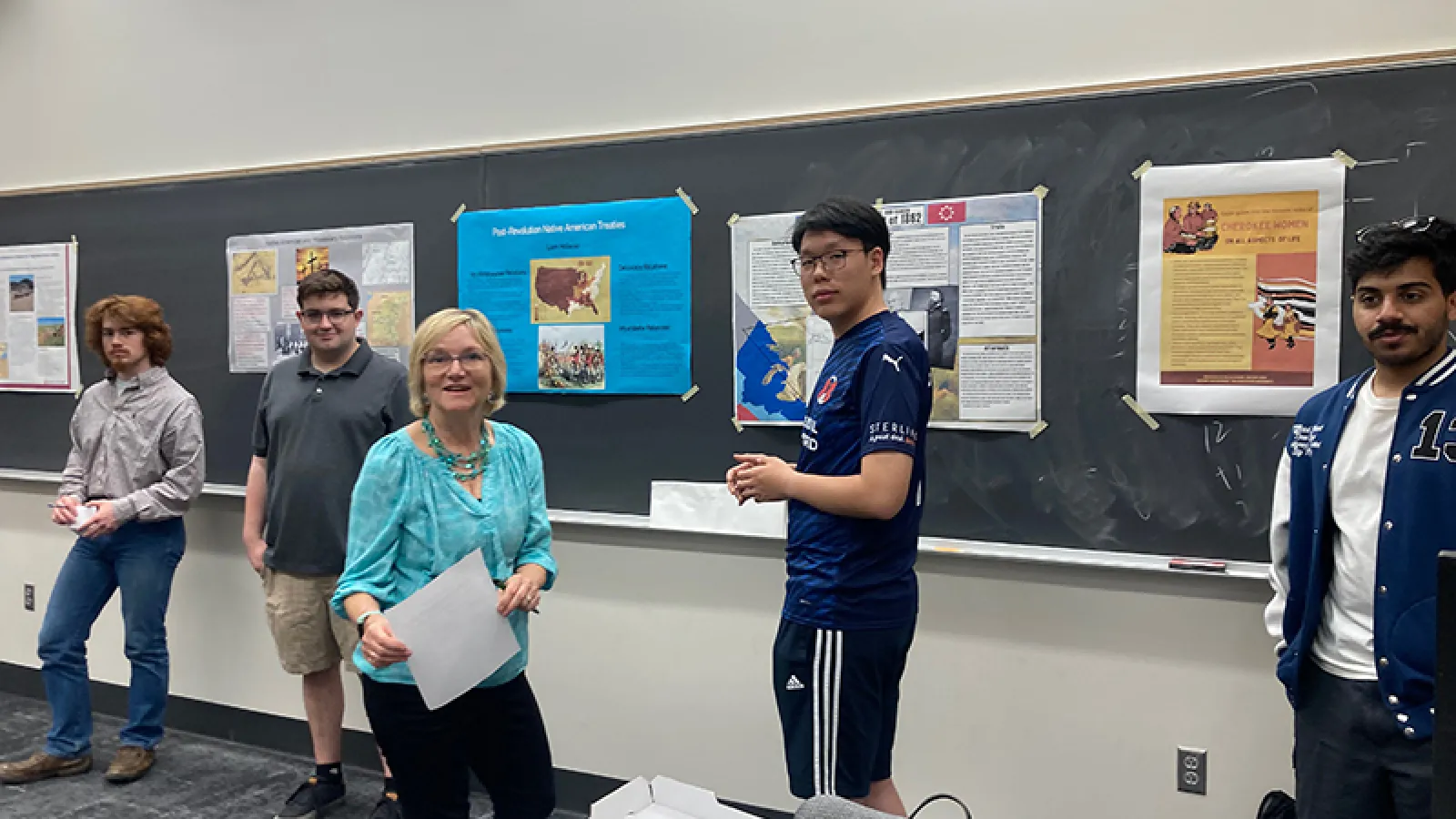 Dr. Lucy Murphy and a student standing in front of posters