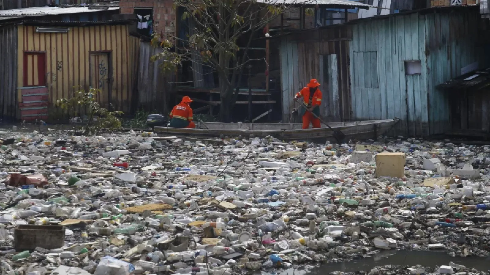 Workers remove garbage floating on the Negro River in Manaus, Brazil. Edmar Barros/AP/AP