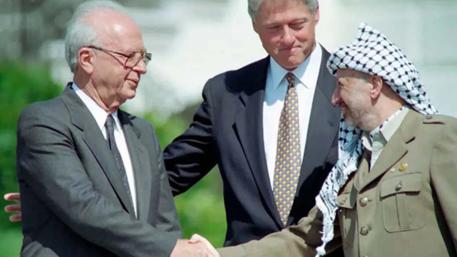 US President Bill Clinton (C) stands between PLO leader Yasser Arafat (R) and Israeli Prime Minister Yitzahk Rabin (L) as they shake hands for the first time, on Sept. 13, 1993 at the White House in Washington, D.C., after signing the historic Israel-PLO Oslo Accords on Palestinian autonomy in the occupied territories.J. David Ake—AFP / Getty Images