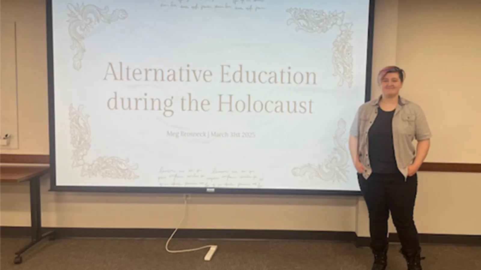 Meg Brosneck standing in front of a title slide of her thesis