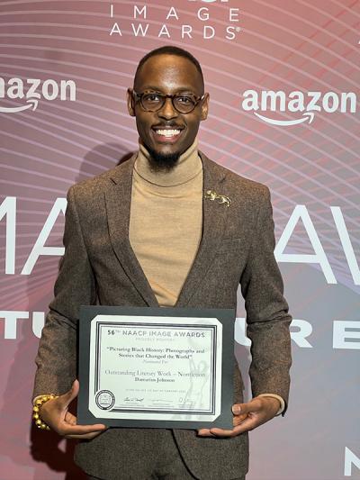 Damarius Johnson holding certificate