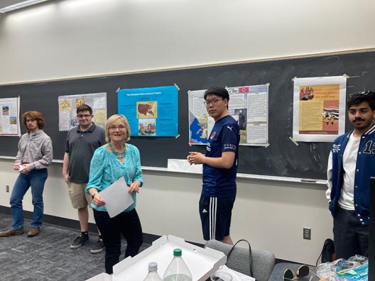 Dr. Lucy Murphy and a student standing in front of posters