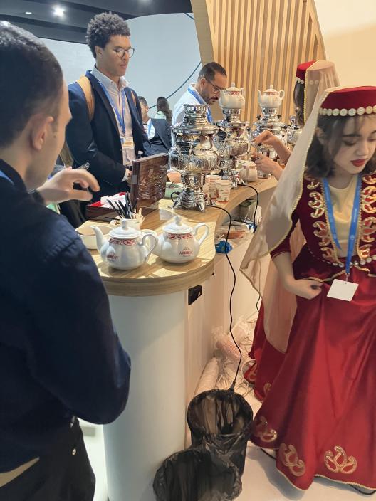 people standing around a table with food on it