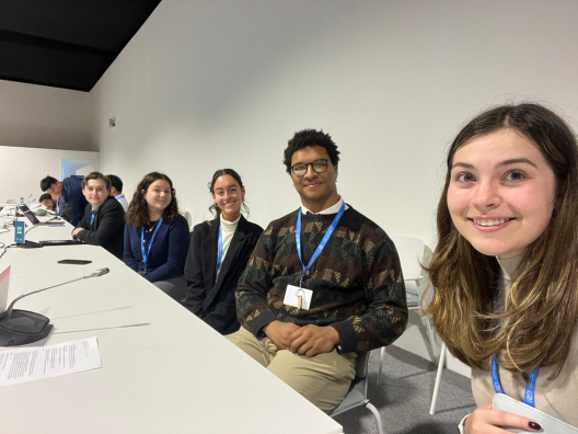 students at COP29 sitting at a table