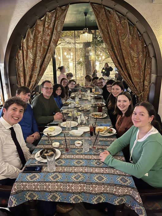 Students and professors sitting at a long table