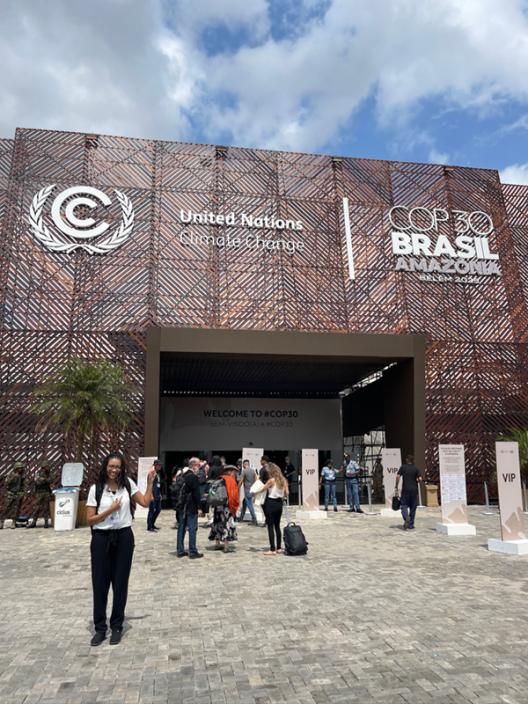 people standing outside the building where COP30 is being held