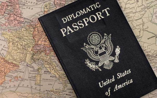a diplomatic passport laying on a map