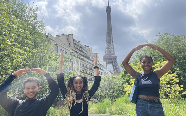 Three Ohio State students pose in front of the Eiffel Tower