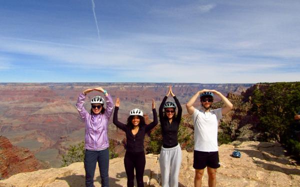 four undergraduate students spelling OHIO in front of the Grand Canyon