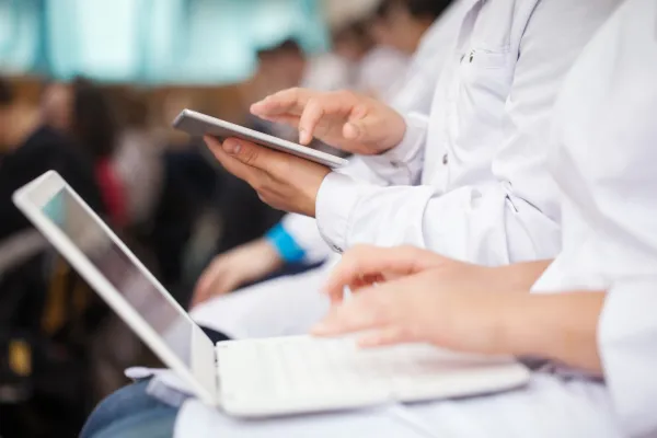 medical students with tablets and laptops