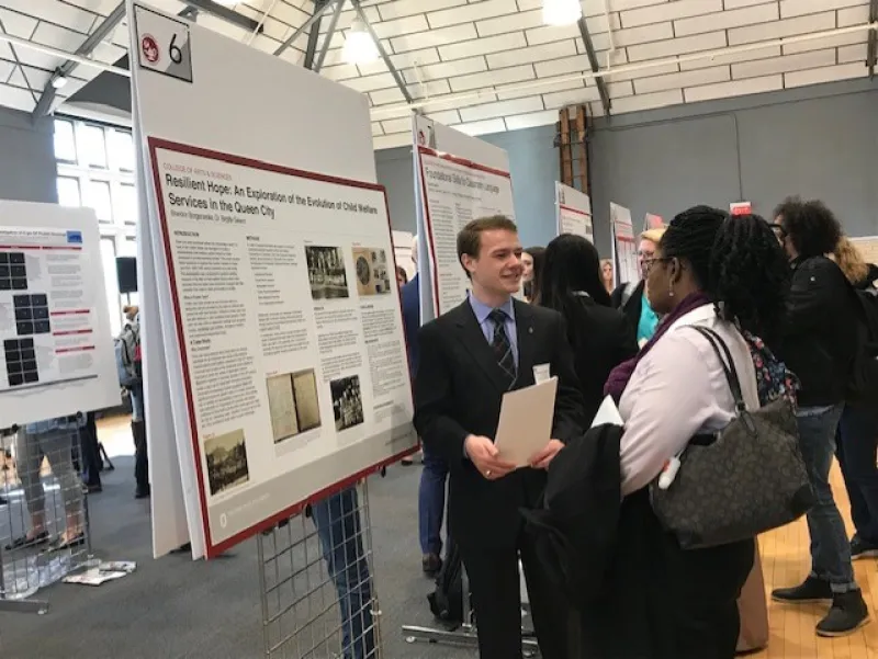 Brandon Borgemenke talks with a judge at the Denman Forum