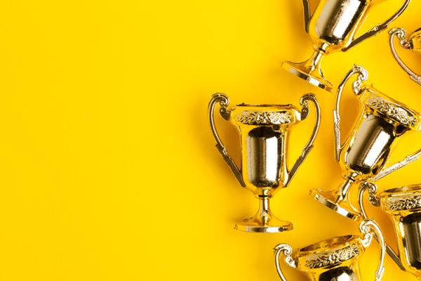awards on a yellow background