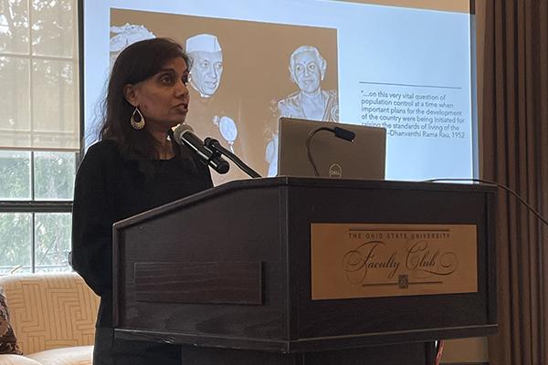 Mytheli Sreenivas standing at a podium