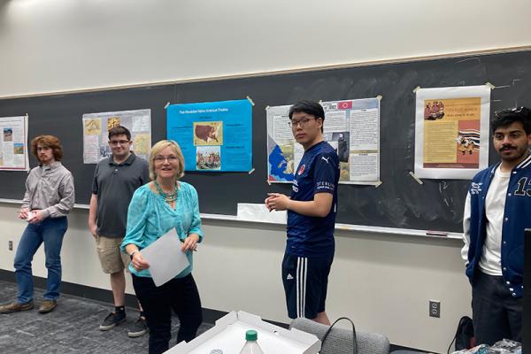 Dr. Lucy Murphy and a student standing in front of posters