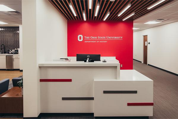 front desk with department of history sign behind it