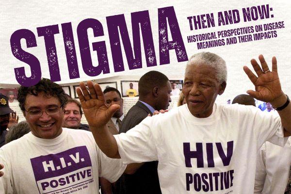 Nelson Mandela with his hands up next to another man, both are wearing shirts referencing HIV
