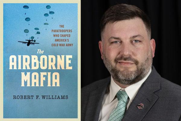 Rob Williams and his book cover with military airplanes in the air