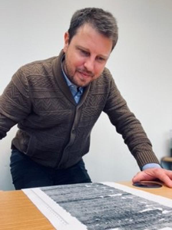 James Moore looking at a print