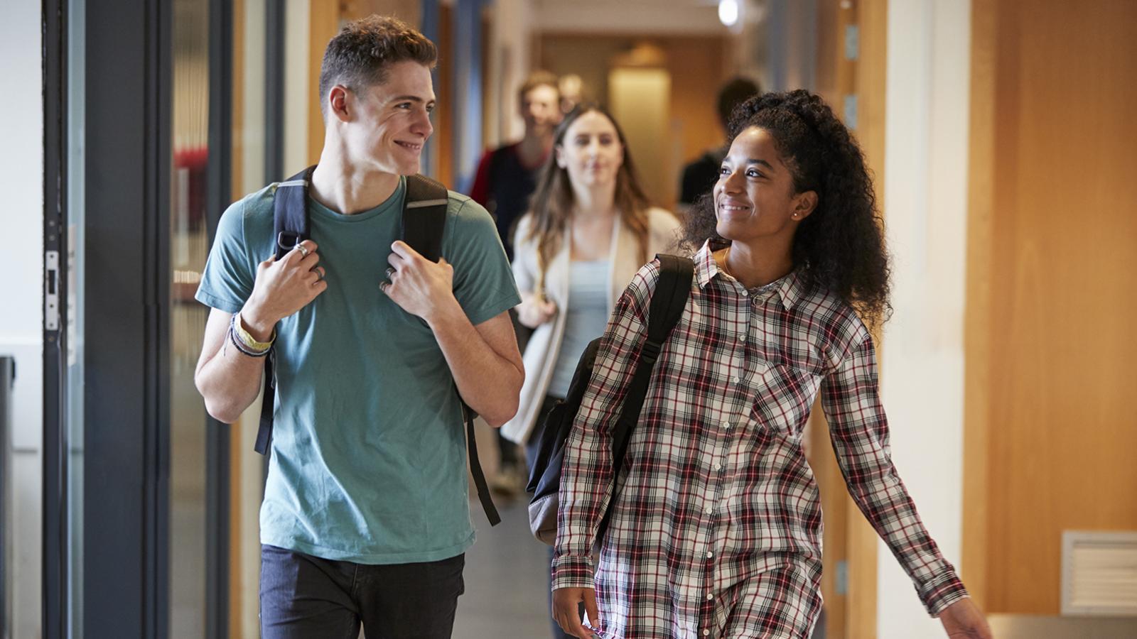 college students walking down a hallway