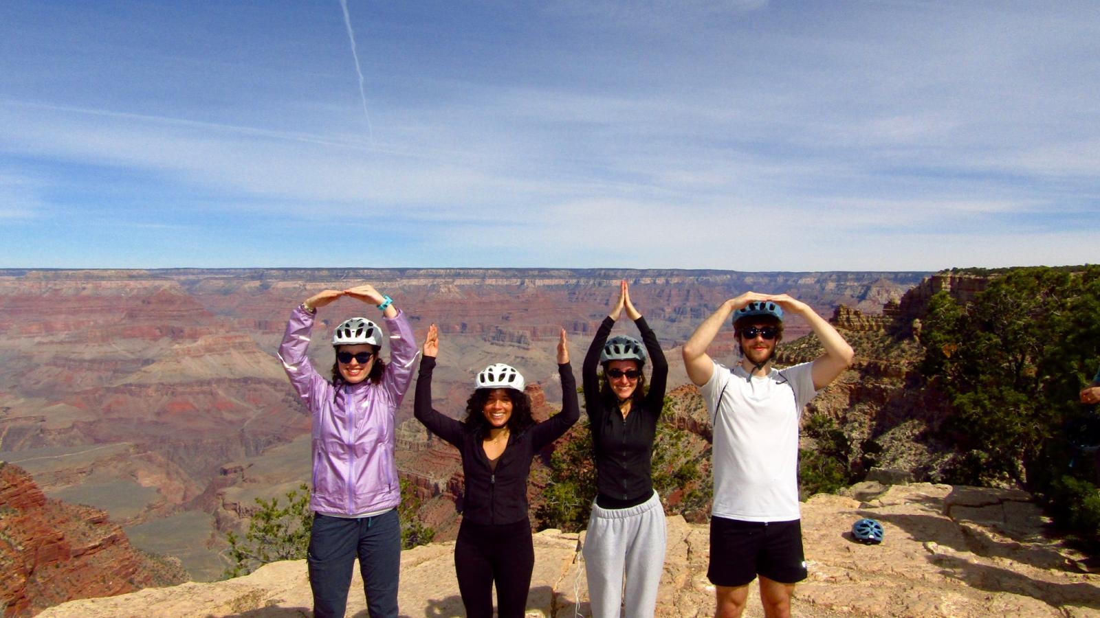 four undergraduate students spelling OHIO in front of the Grand Canyon