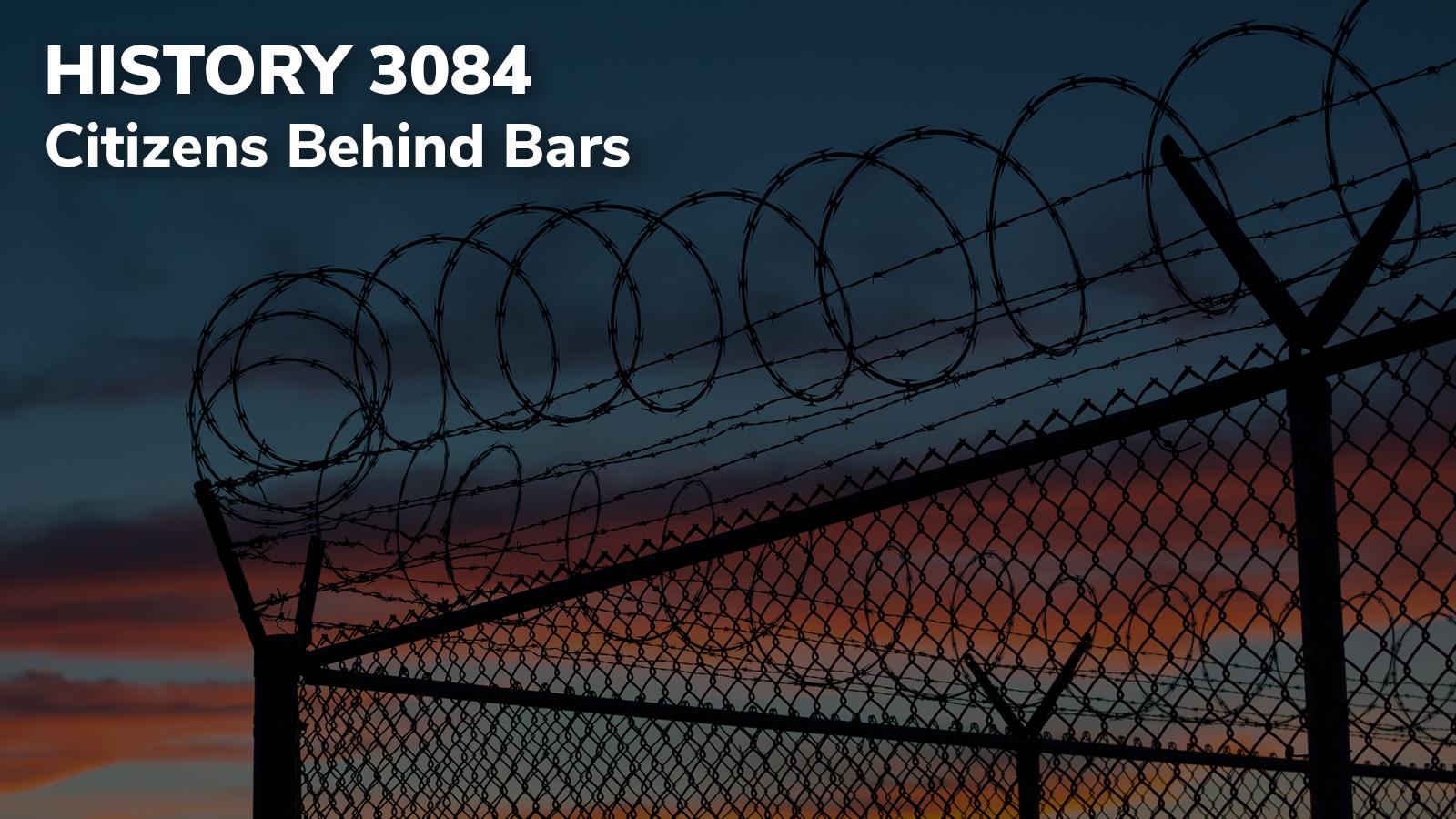 Razorwire fence silhouetted against the sunset and darkening sky